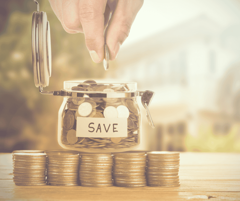 Money Being Saved In Jar